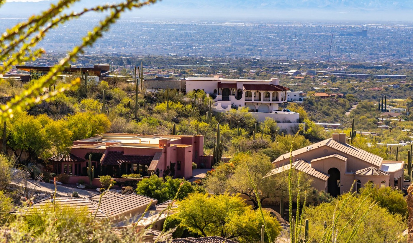 Tucson foothills homes among saguaros, looking out over the city